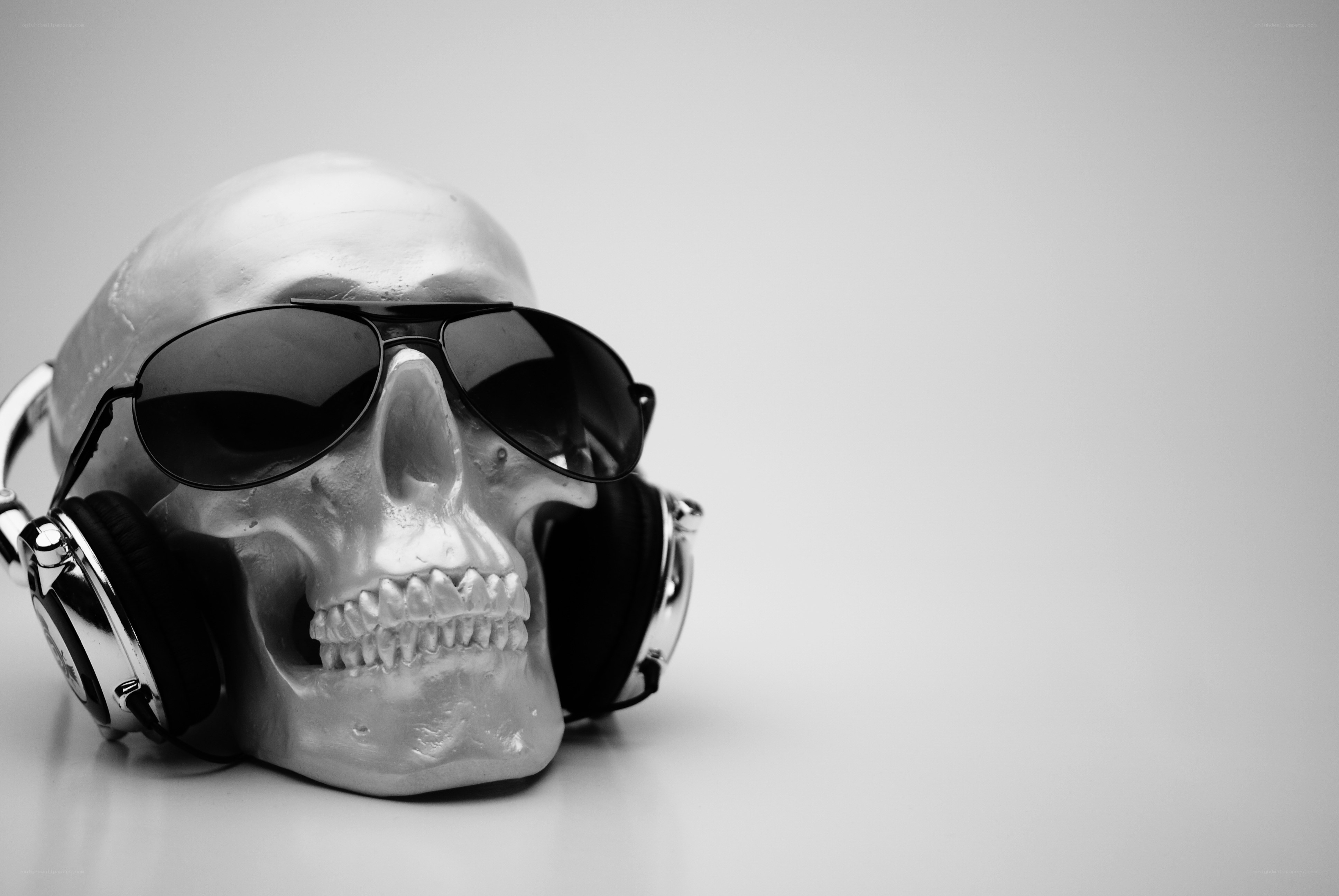 skull with headphones and sunglasses