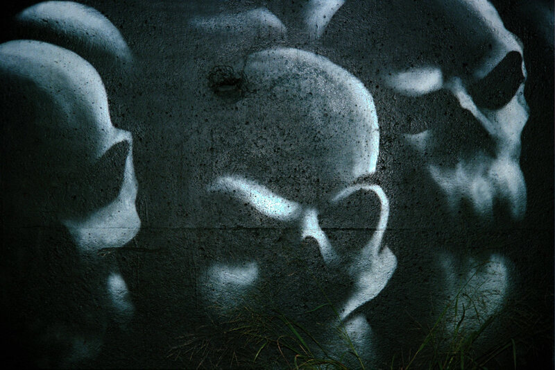 skulls graffiti on concrete wall