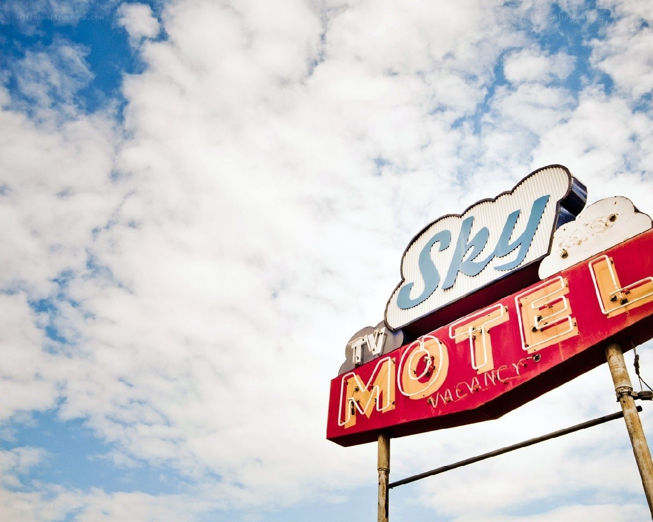 Sky Motel sign against clouds