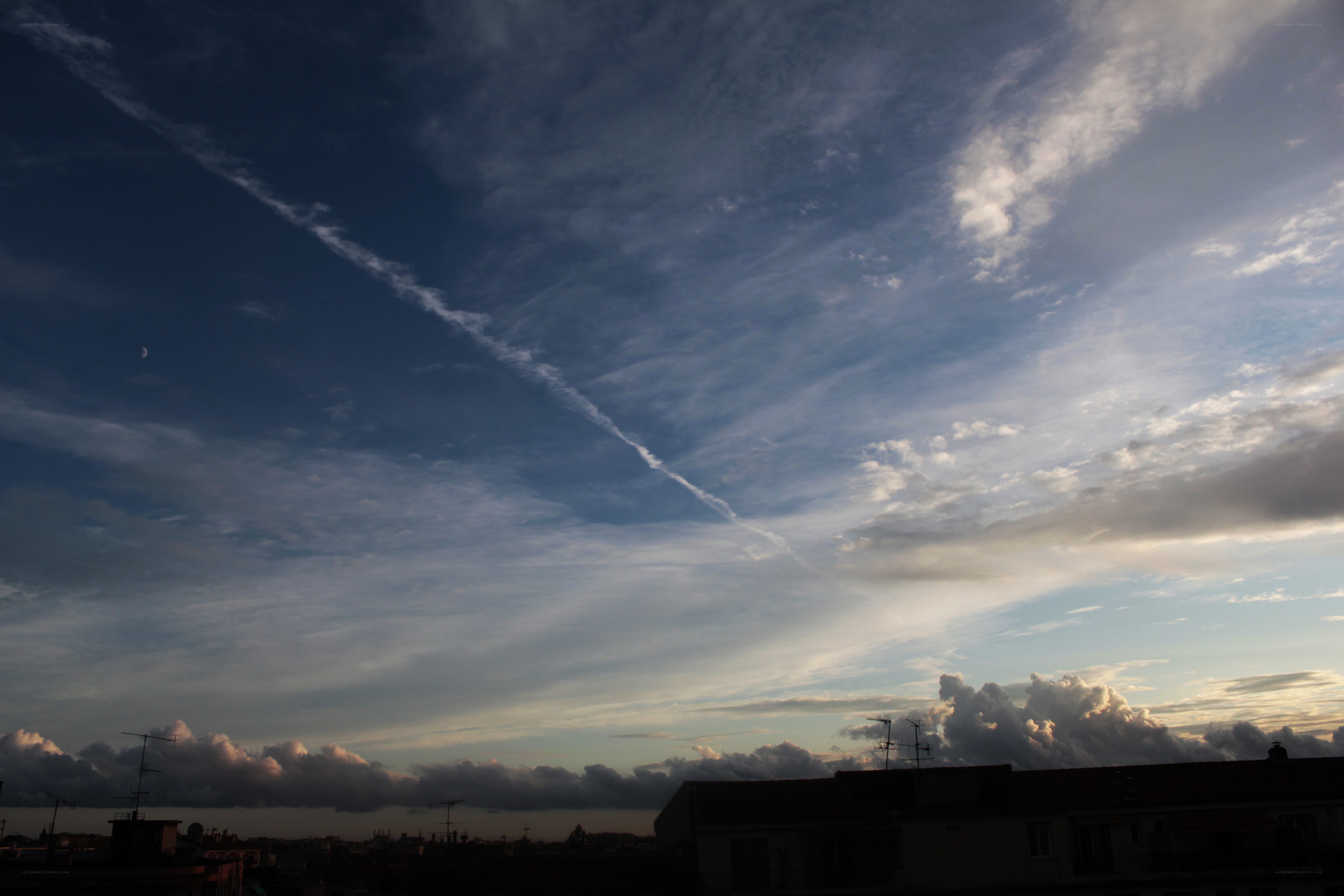Sky with contrail and moon