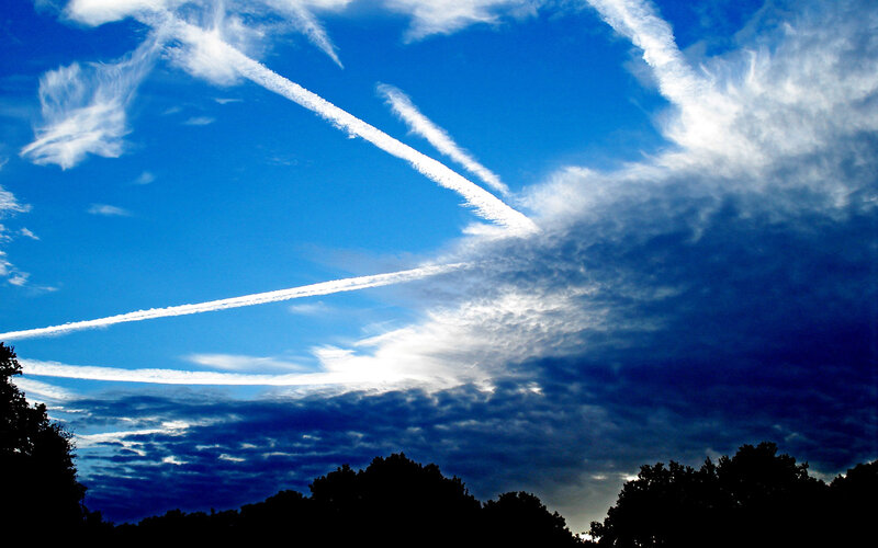 Sky with contrails and clouds