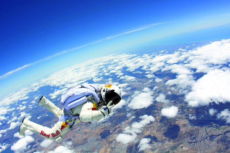 Skydiver above clouds