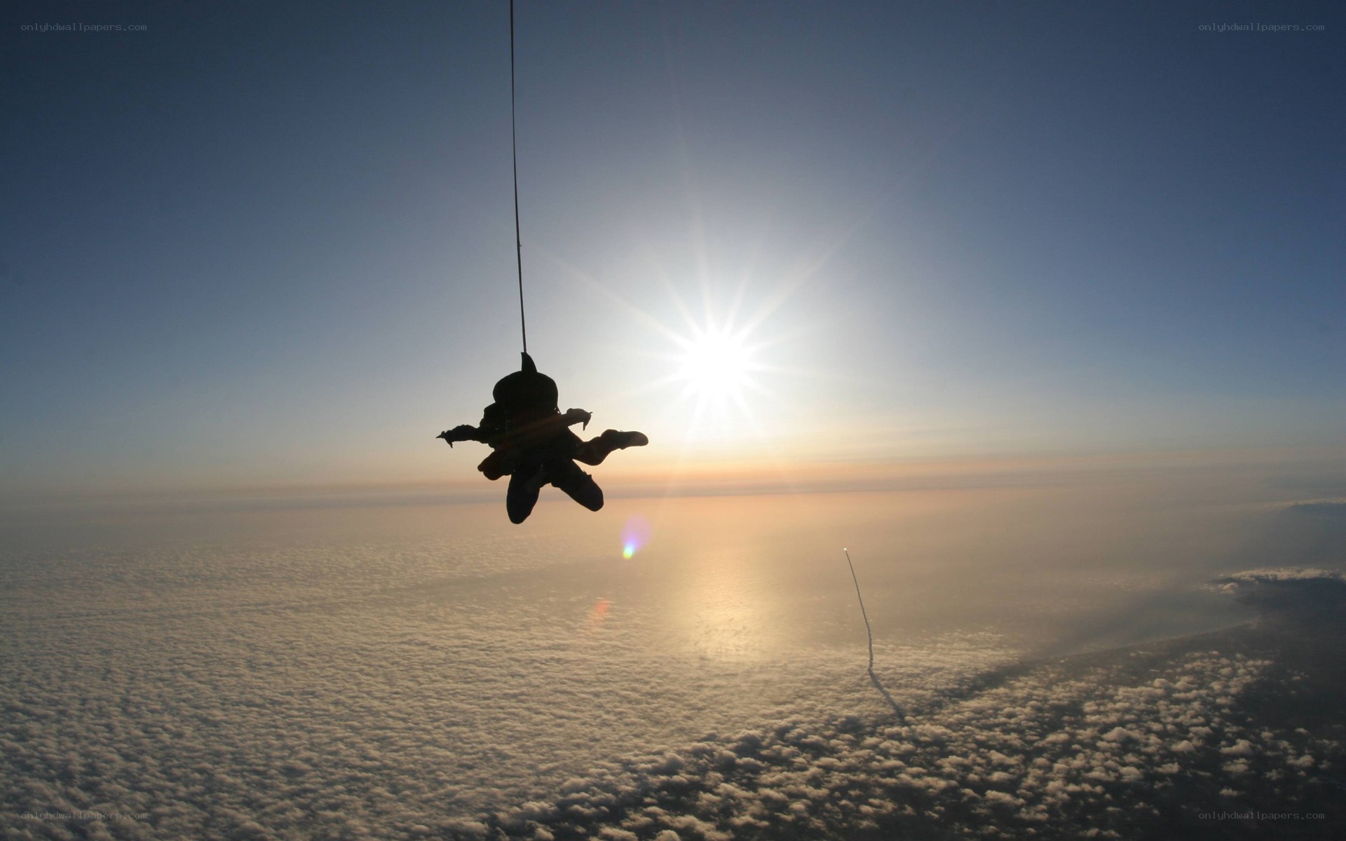 skydiver above clouds at sunrise