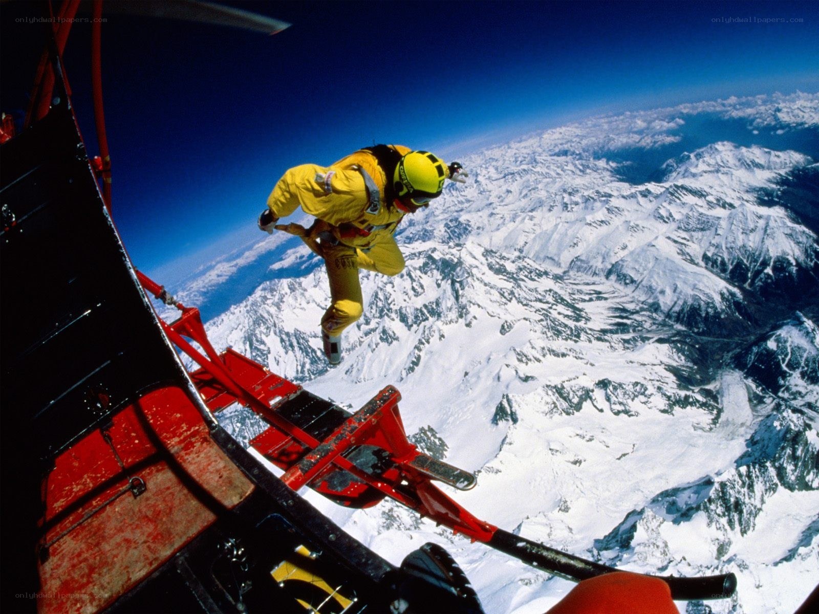 Skydiver above snowy mountains