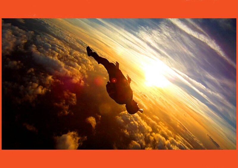 Skydiver in Silhouette — Orange