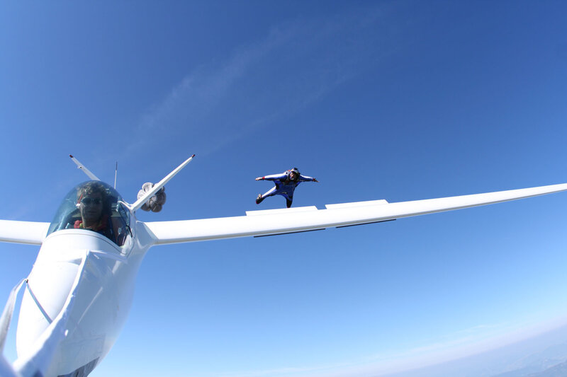 Skydiver jumping from glider