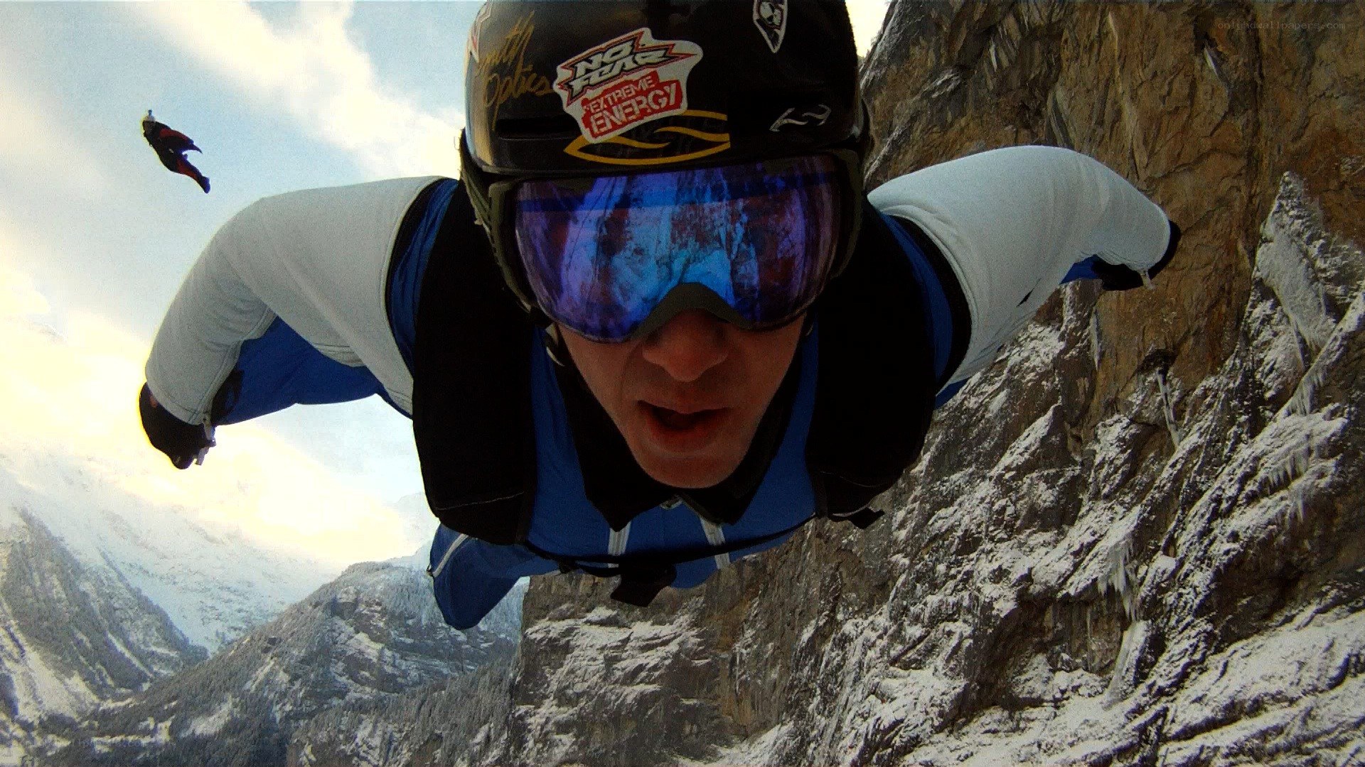 Skydiver near mountain cliff