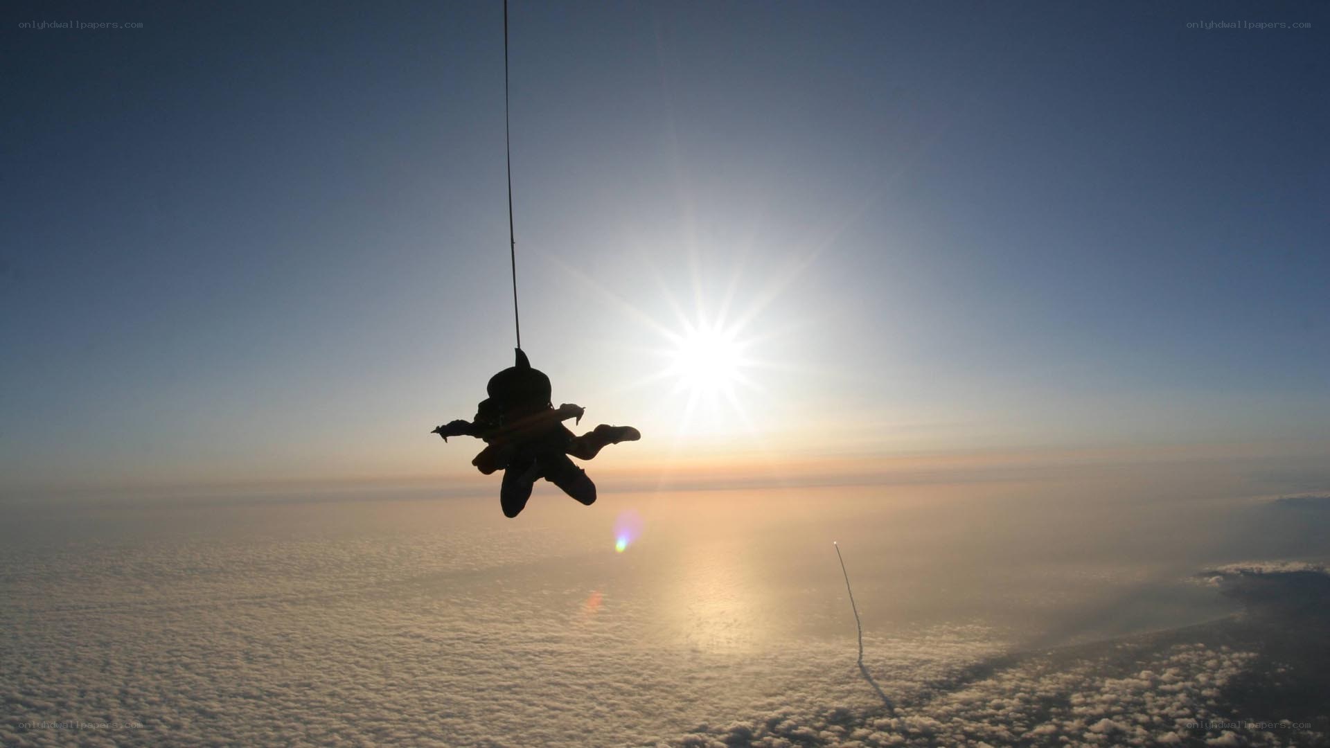Skydiver silhouetted against sun