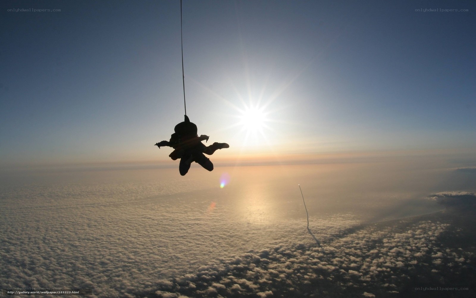 Skydiver silhouetted against sun