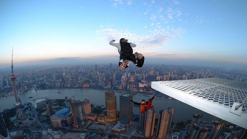 Skydivers Above City — Blue, Dramatic