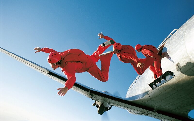 Skydivers exiting aircraft