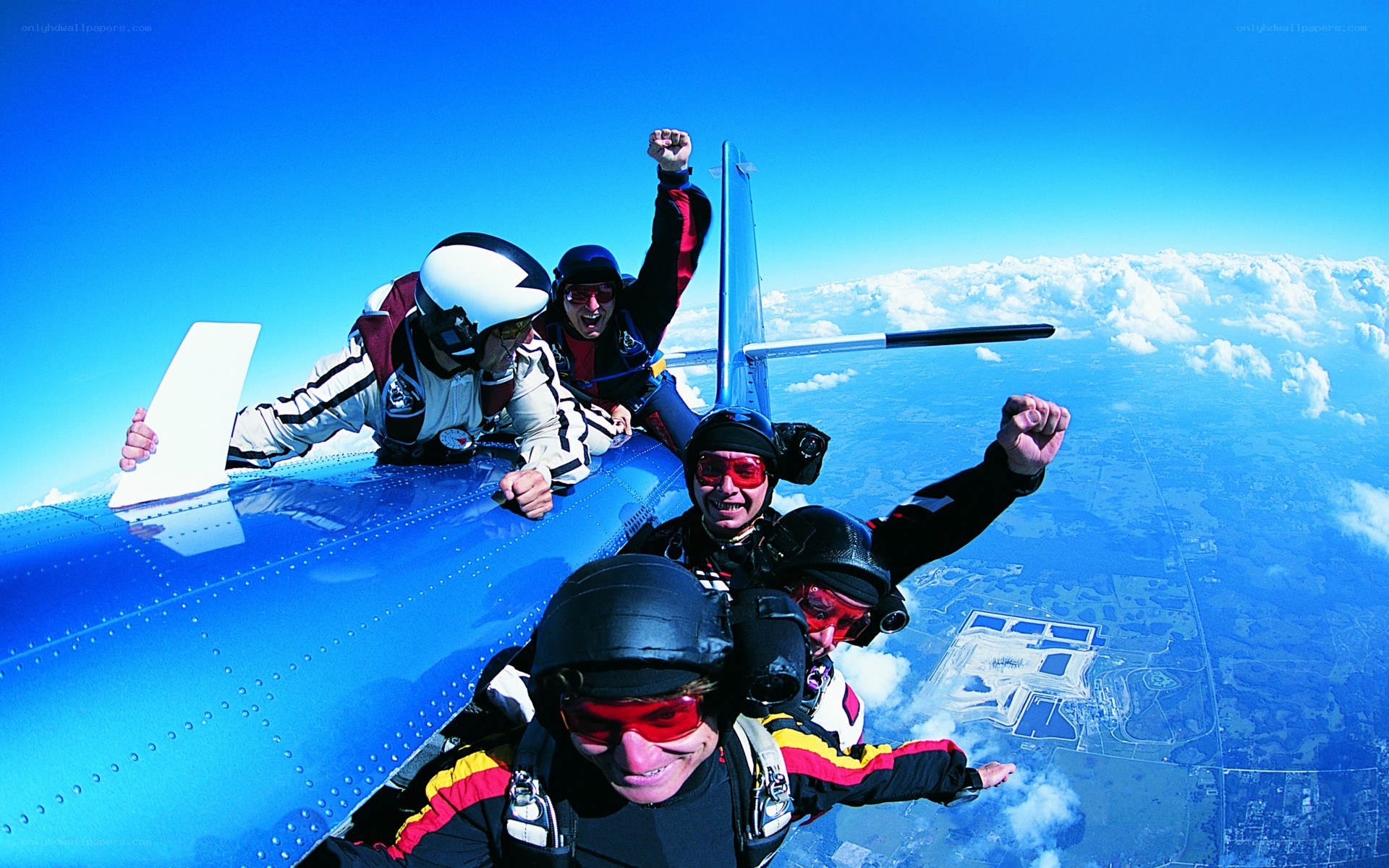 Skydivers exiting an airplane