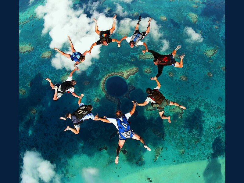 Skydivers form circle over ocean