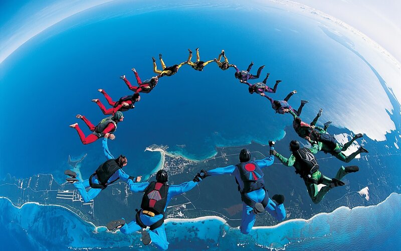 Skydivers Forming Circle — Blue, Dramatic, Afternoon, Photograph, Ocean, Coastline