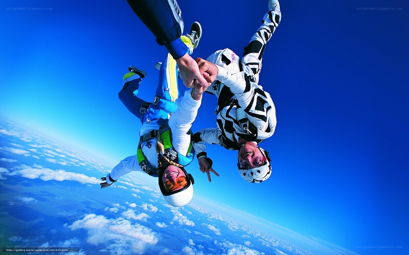 Skydivers holding hands in freefall