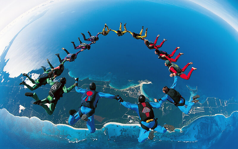 Skydivers in Formation — Blue, Dramatic, Afternoon, Photograph, Ocean, Coastline