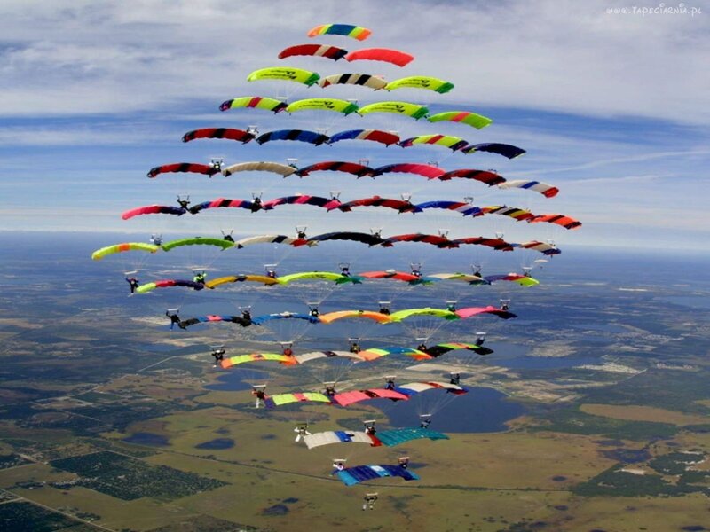Skydivers in Formation — Blue, Dynamic, Afternoon, Photograph, Parachutes
