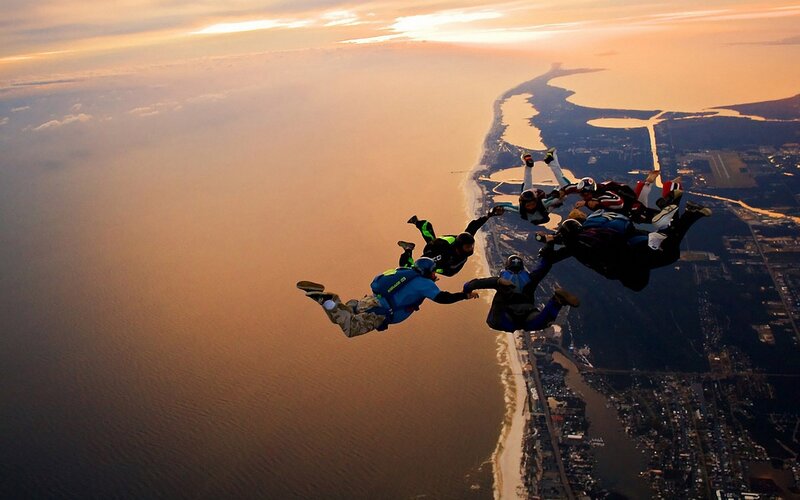 Skydivers in Formation — Orange, Dramatic