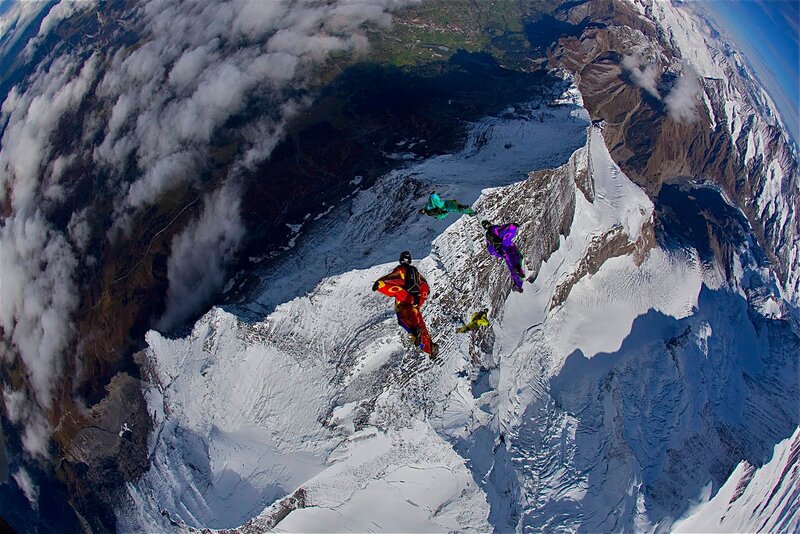 Skydivers over snowy mountains