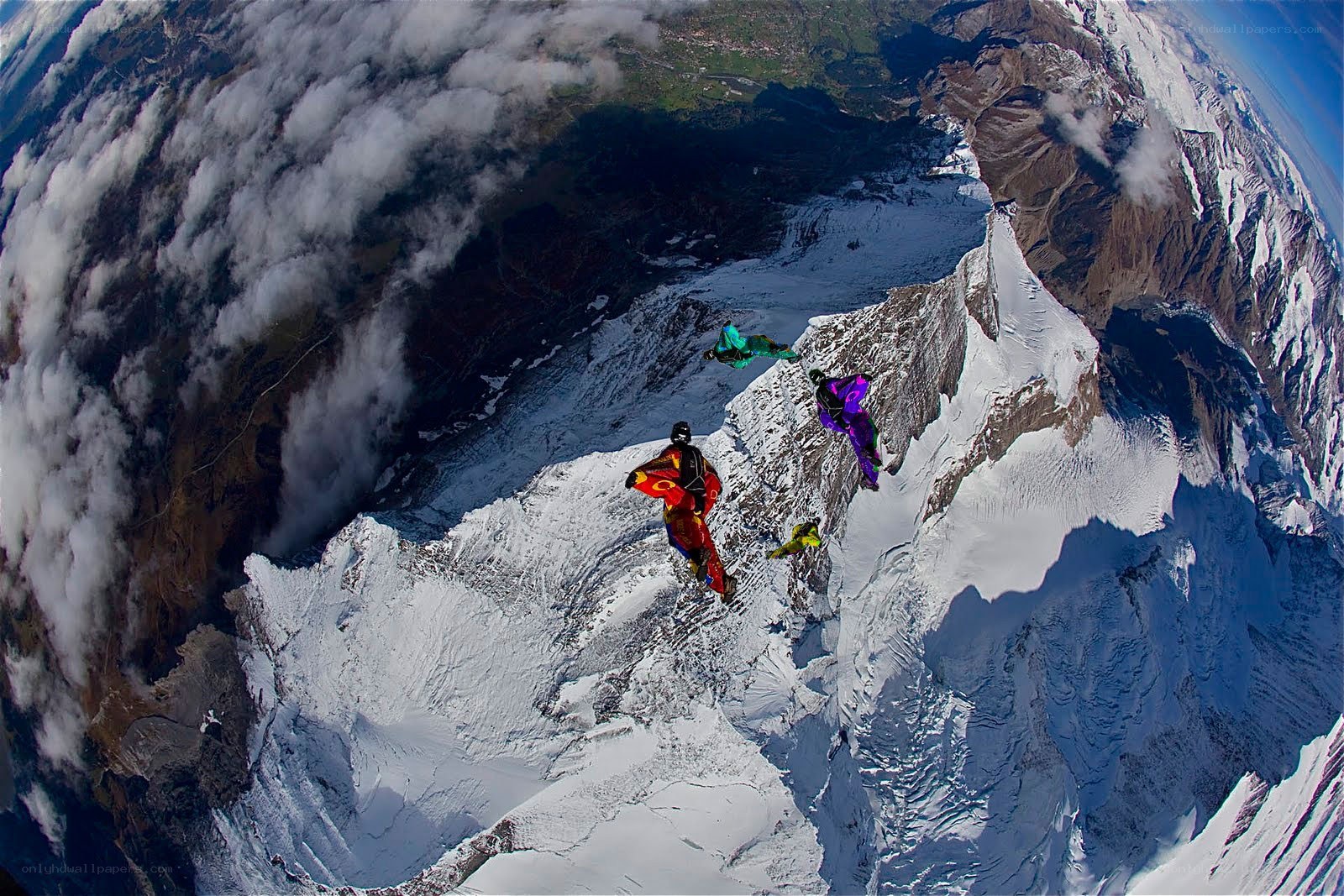 Skydivers over snowy mountains