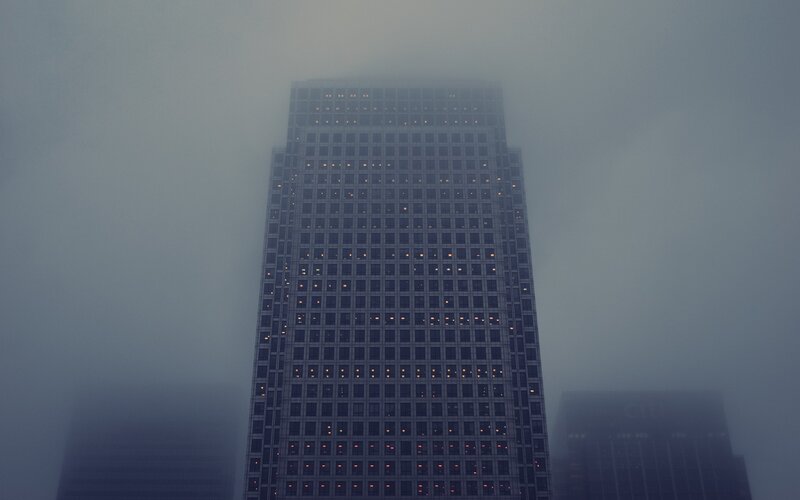 Skyscraper in foggy city