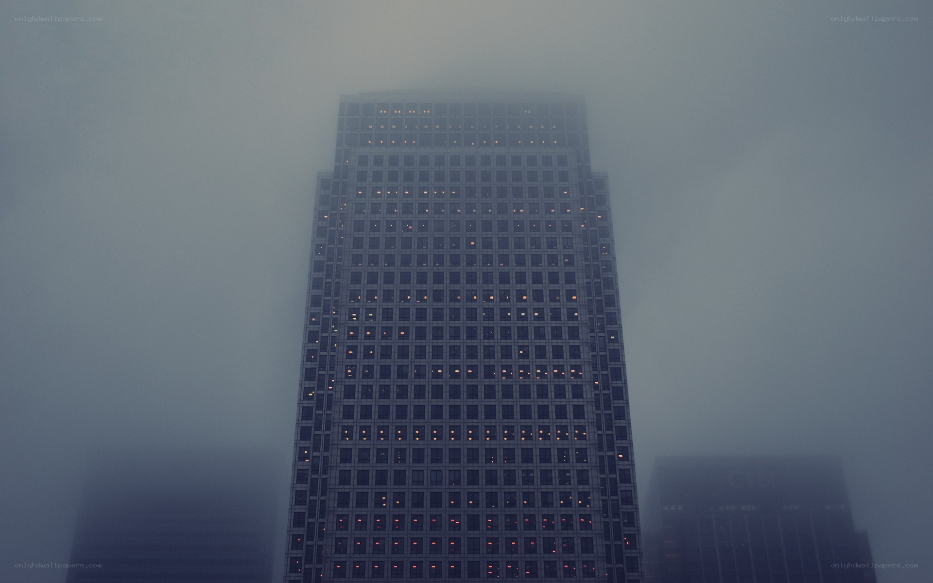 Skyscraper in foggy city