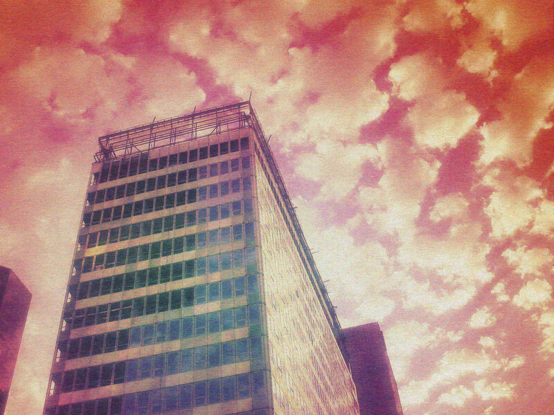 skyscraper under colorful sky