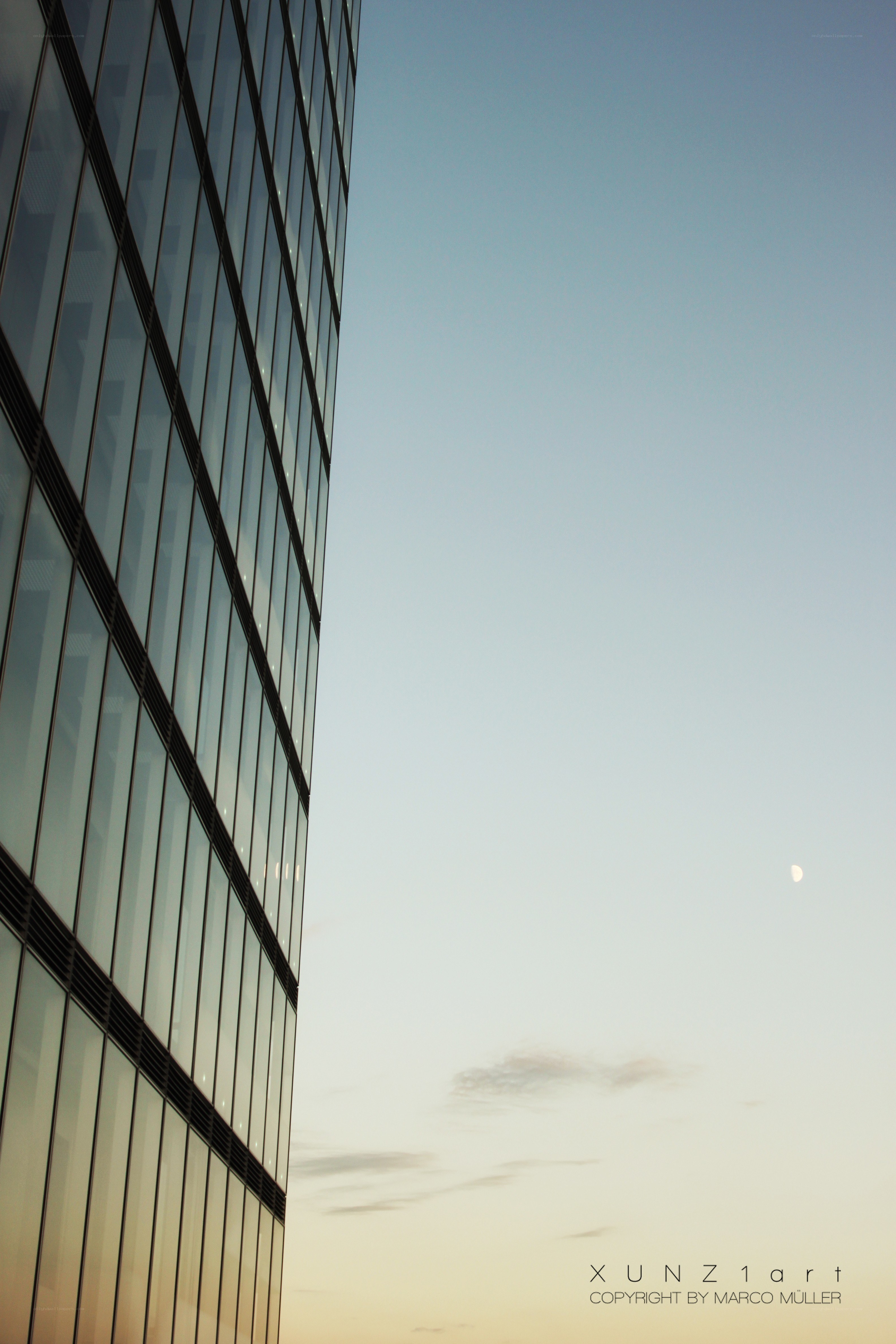 skyscraper with moon at dusk