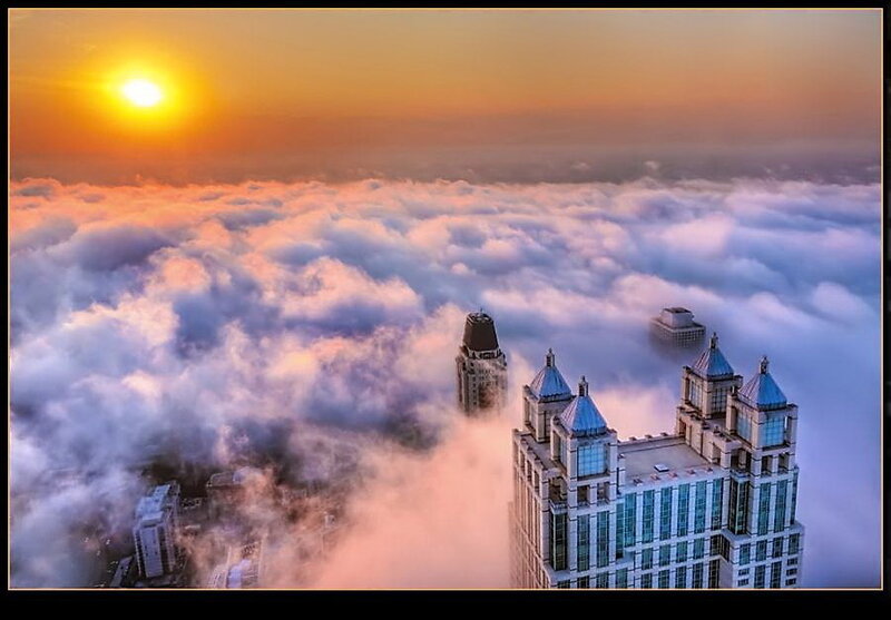 Skyscrapers Above Clouds — Orange