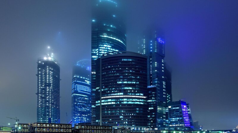 skyscrapers in fog at night