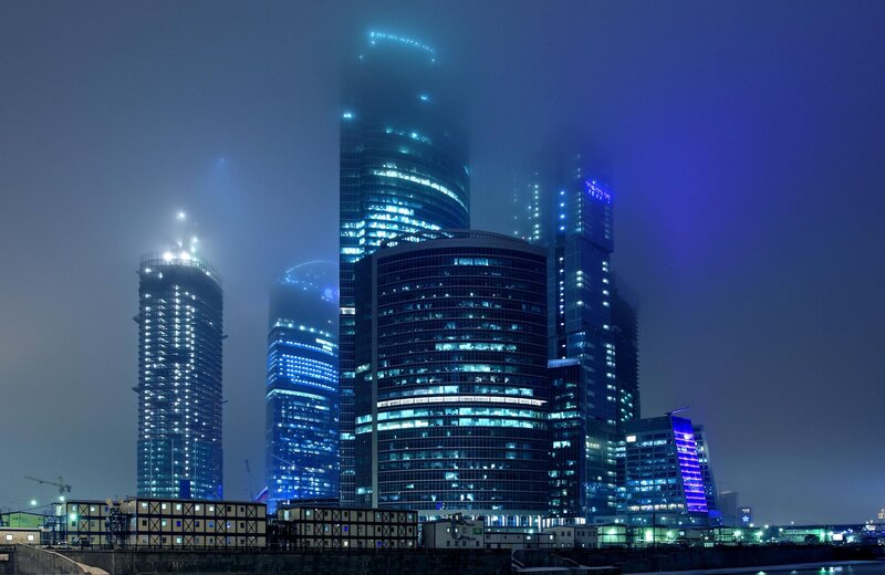Skyscrapers in fog at night