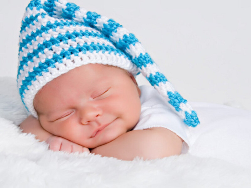 sleeping baby in blue hat