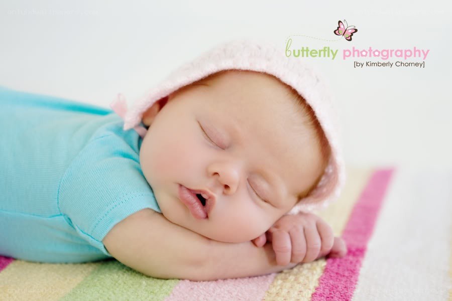 Sleeping baby in pink hat