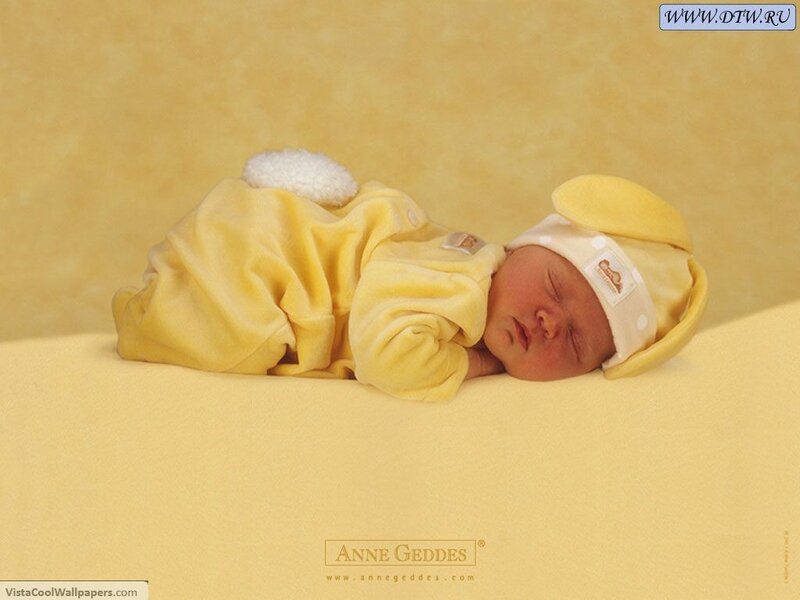 Sleeping baby in yellow outfit