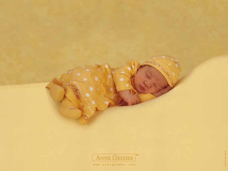 Sleeping baby in yellow polka dot outfit