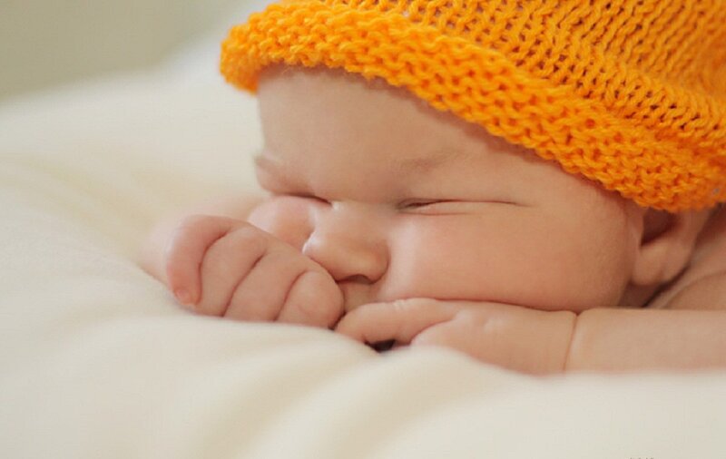 Sleeping Baby Wearing Hat — Orange