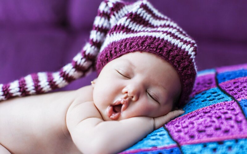 Sleeping Baby Wearing Hat — Purple