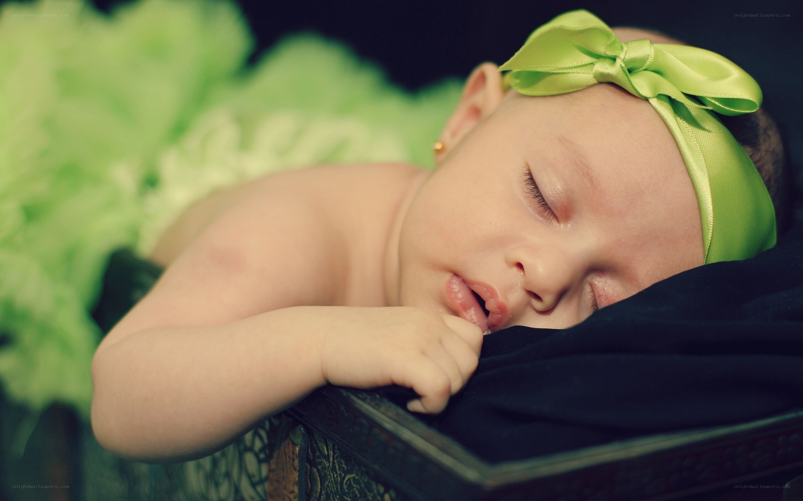 sleeping baby with green bow