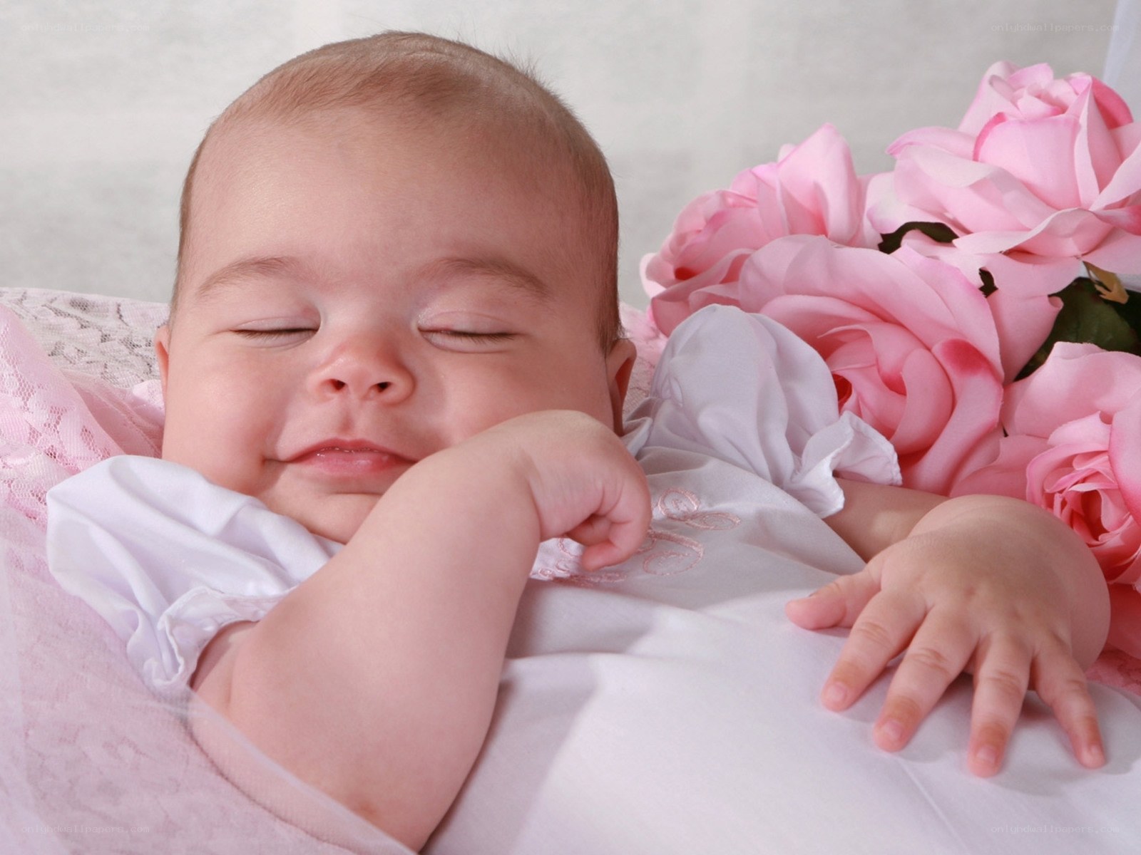 sleeping baby with pink roses