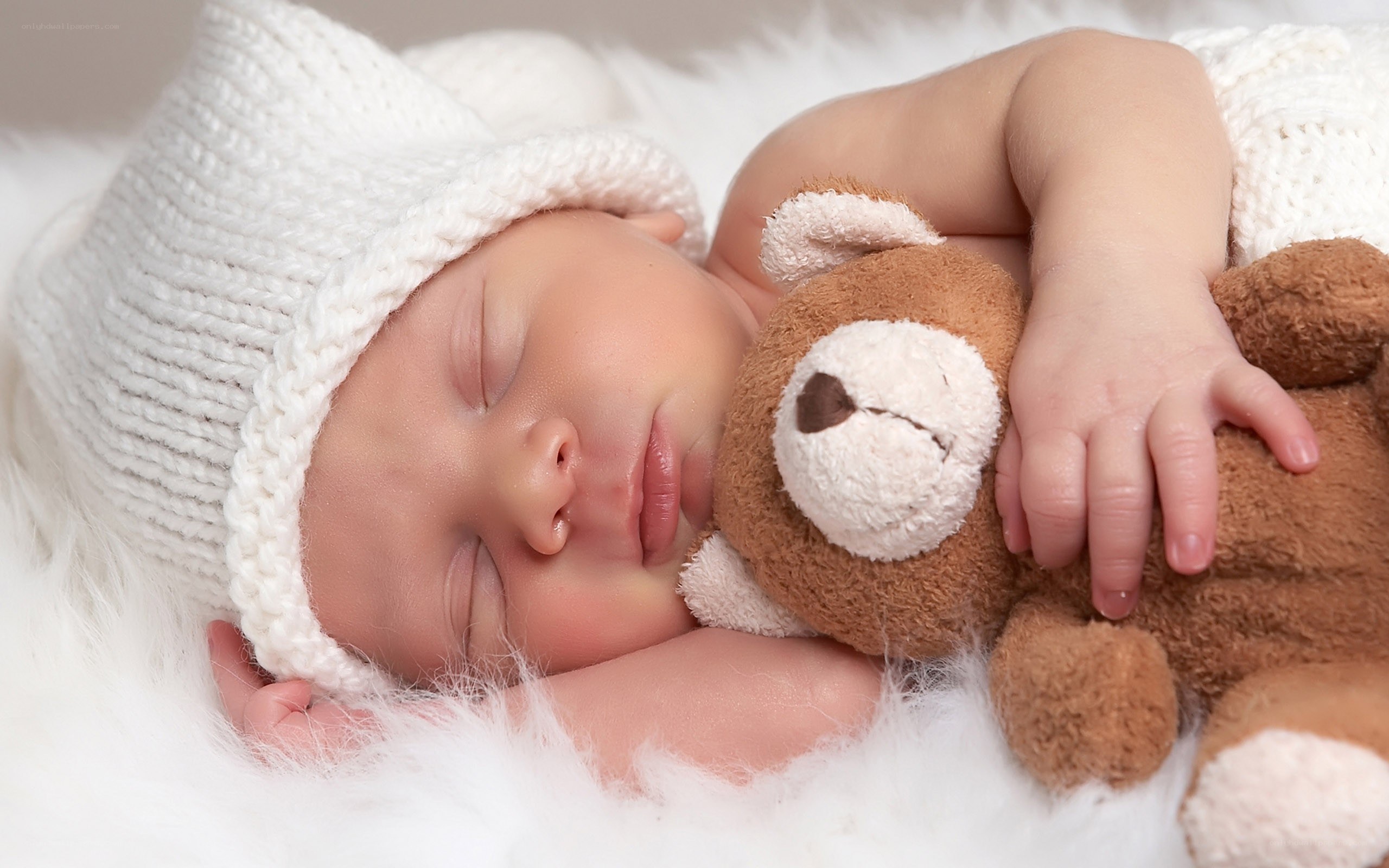 sleeping baby with teddy bear