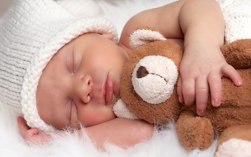 Sleeping baby with teddy bear