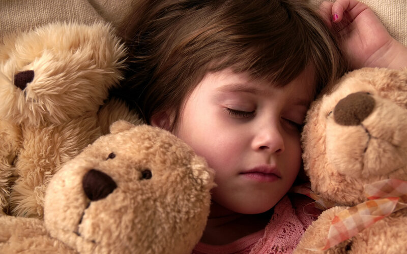 Sleeping Child with Teddy Bears