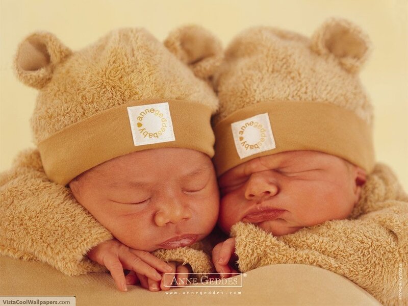 Sleeping twin babies in bear hats