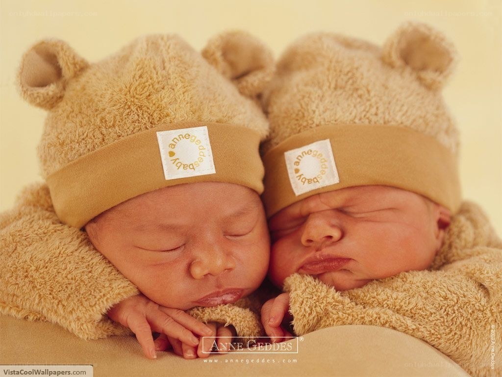 Sleeping twin babies in bear hats