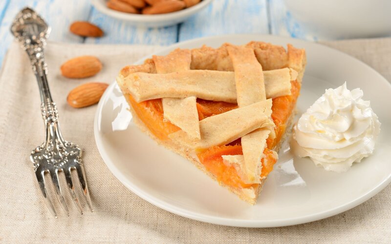 slice of apricot pie with whipped cream