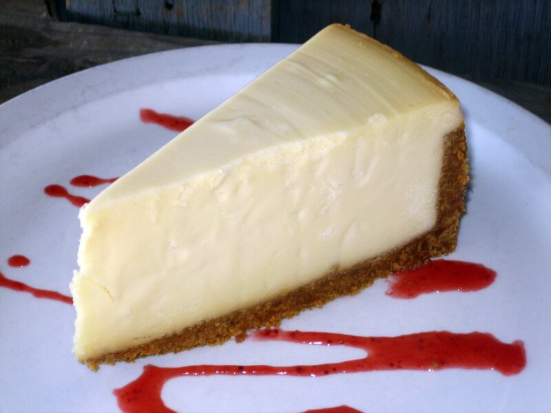 slice of cheesecake with berry sauce