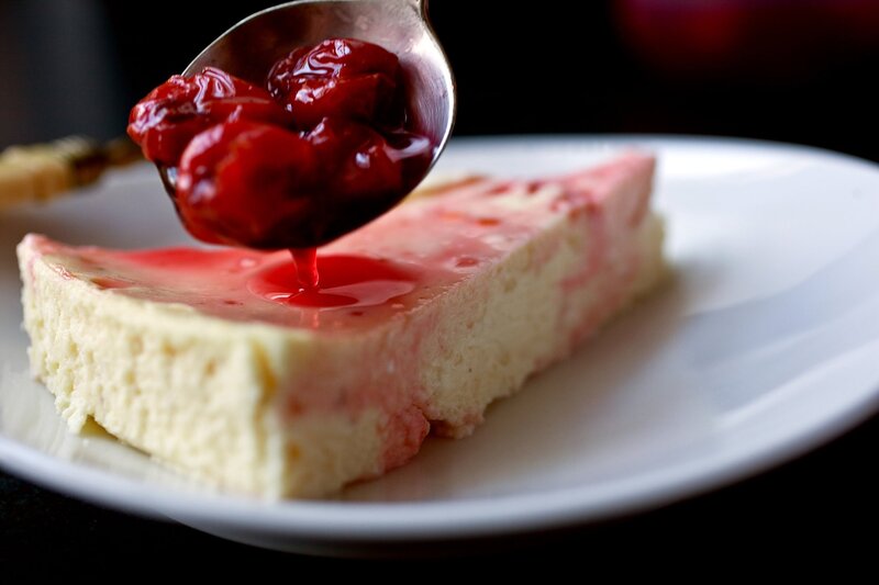 Slice of Cheesecake with Cherry Sauce
