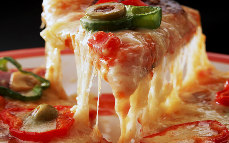 Slice of cheesy pizza with olives