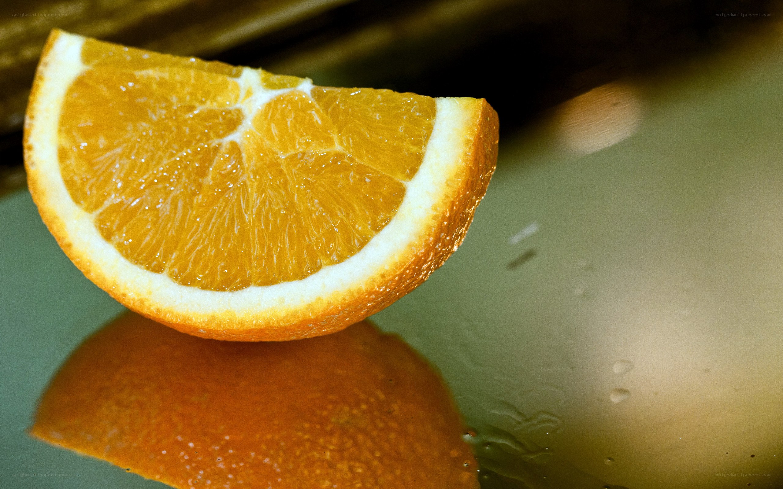 slice of orange on wet surface