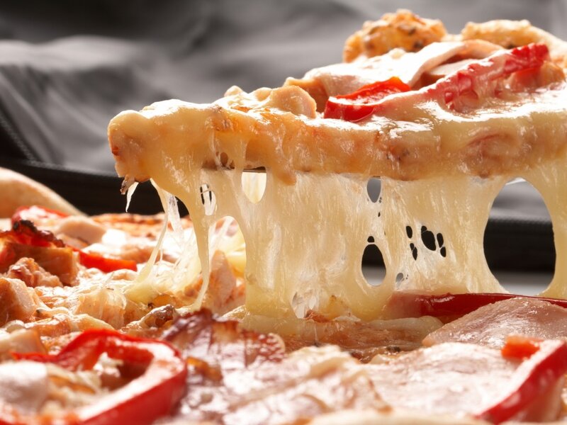 Slice of Pizza Being Lifted — Yellow